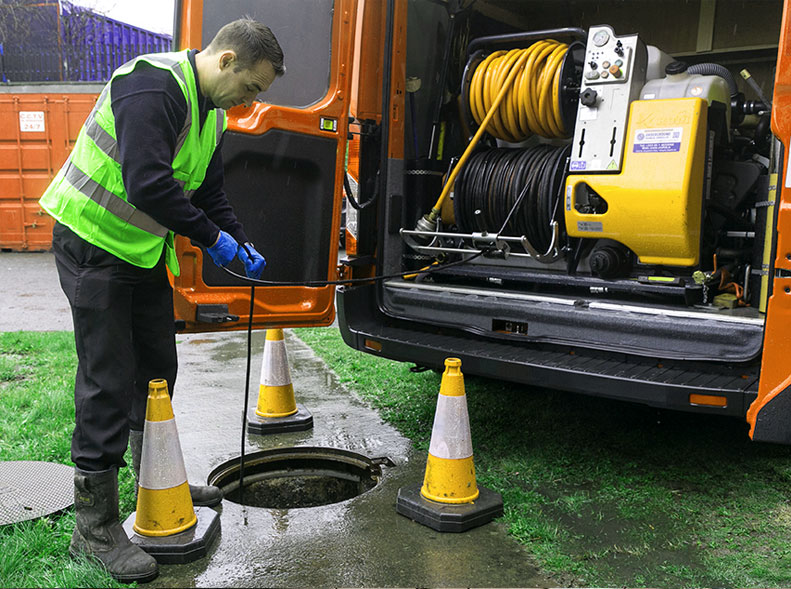 Man clearing drain in Birmingham